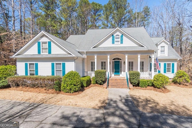 neoclassical / greek revival house with covered porch and a shingled roof