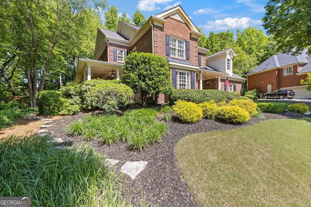 view of side of home with brick siding and a yard
