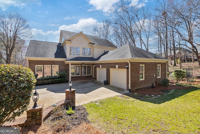 traditional home featuring an attached garage, brick siding, a front lawn, and concrete driveway