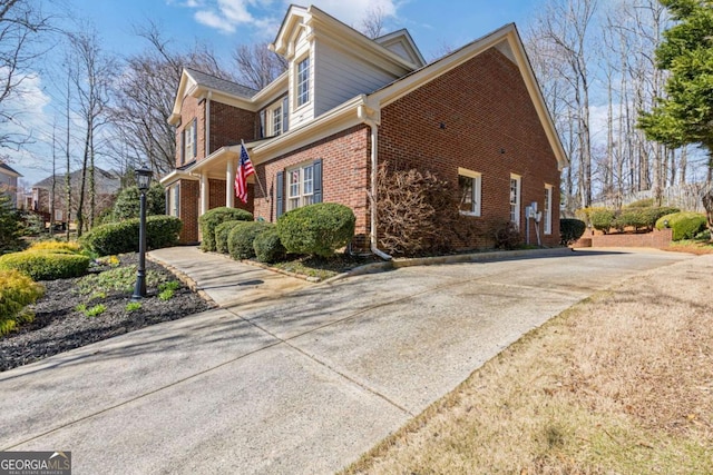 view of side of home featuring brick siding