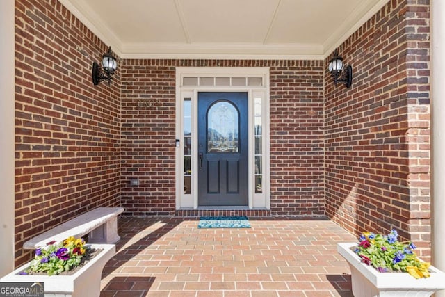 doorway to property featuring brick siding