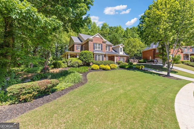 view of front of house featuring a front yard and brick siding