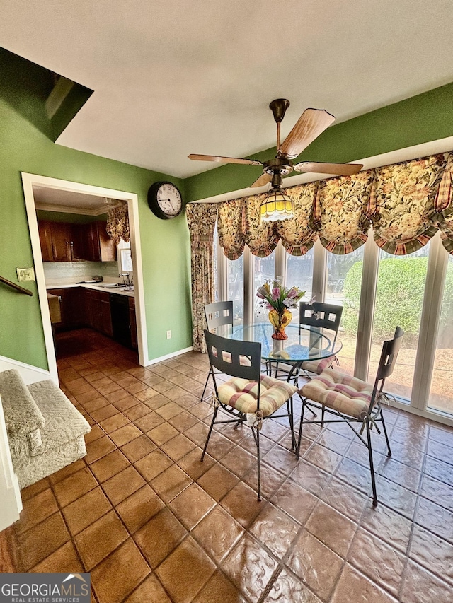 dining room with baseboards and a ceiling fan