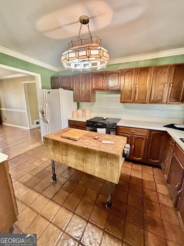 kitchen featuring ornamental molding, black electric range oven, backsplash, white fridge with ice dispenser, and light countertops