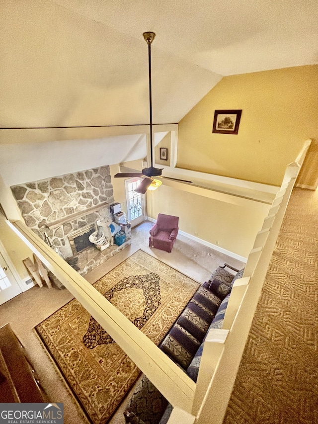 stairs featuring a ceiling fan, a textured ceiling, carpet floors, baseboards, and vaulted ceiling