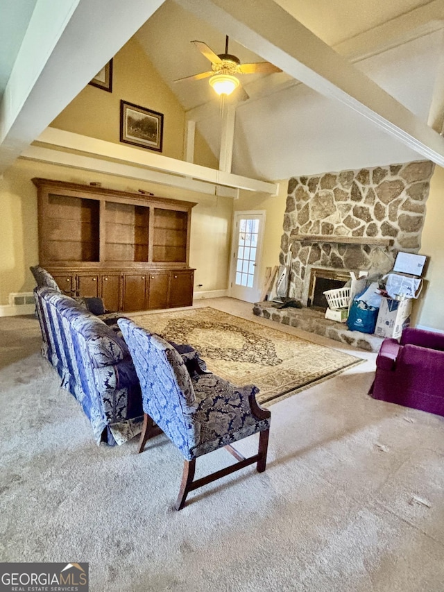 living room with ceiling fan, beamed ceiling, carpet flooring, a fireplace, and high vaulted ceiling