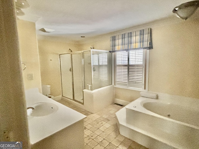 bathroom with visible vents, ornamental molding, a stall shower, a bath, and a sink