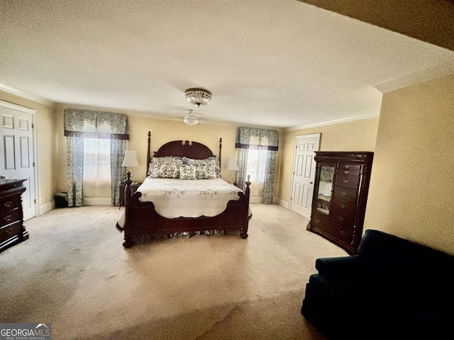 bedroom with multiple windows, carpet floors, and a textured ceiling