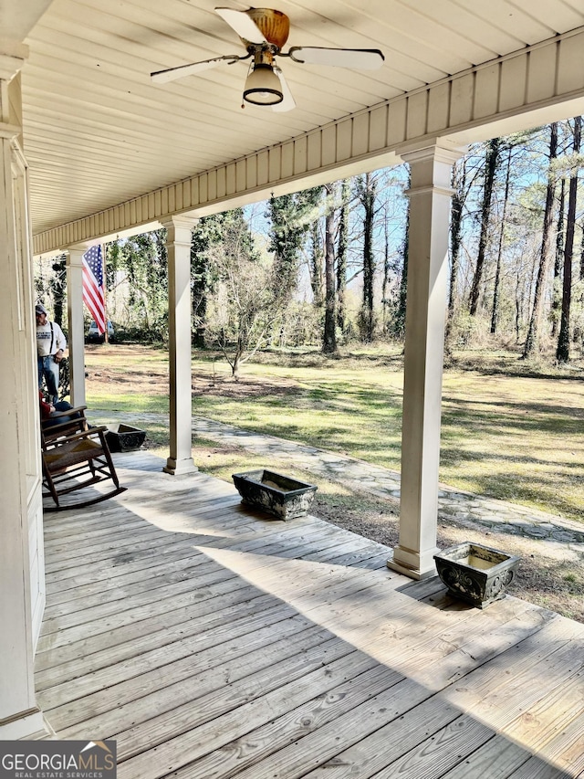 wooden deck featuring a ceiling fan