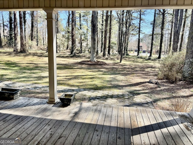 wooden terrace with a lawn