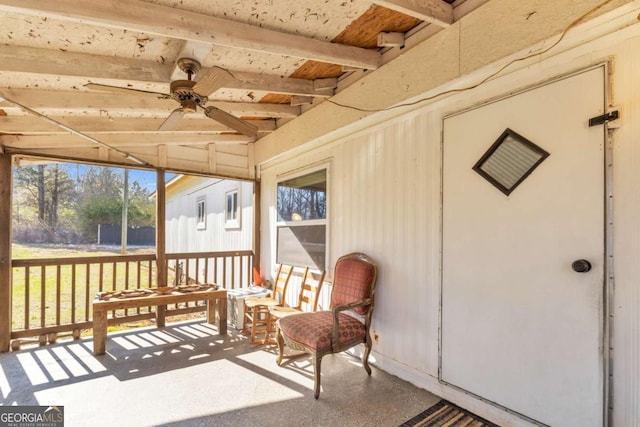 sunroom featuring a ceiling fan