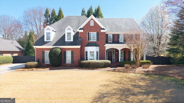 view of front of house with a front lawn and brick siding