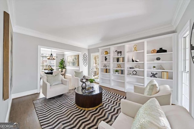 sitting room featuring baseboards, an inviting chandelier, wood finished floors, and crown molding