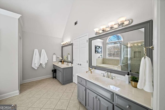 bathroom featuring visible vents, a stall shower, a sink, tile patterned flooring, and vaulted ceiling