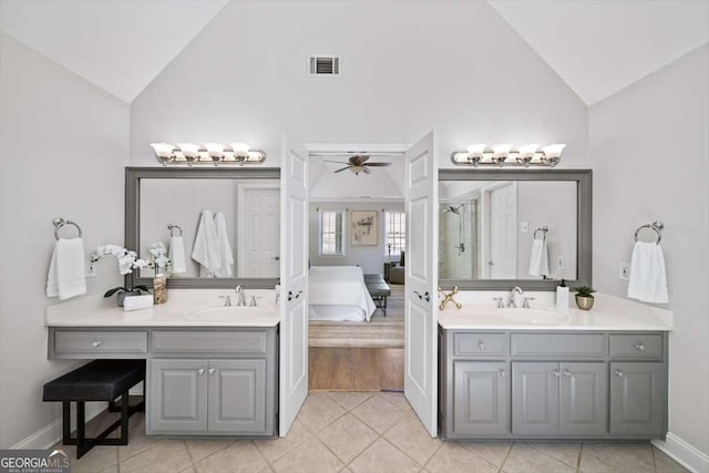 full bath with a sink, visible vents, and two vanities