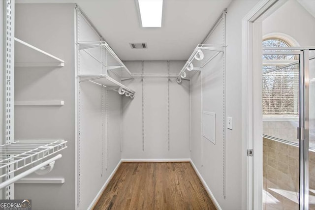 spacious closet with visible vents and wood finished floors