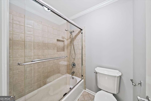 bathroom featuring toilet, baseboards, bath / shower combo with glass door, and ornamental molding