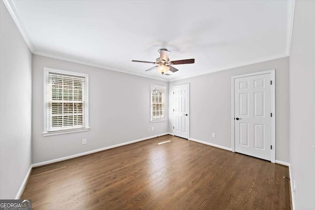 unfurnished bedroom with dark wood-style floors, a ceiling fan, baseboards, and ornamental molding