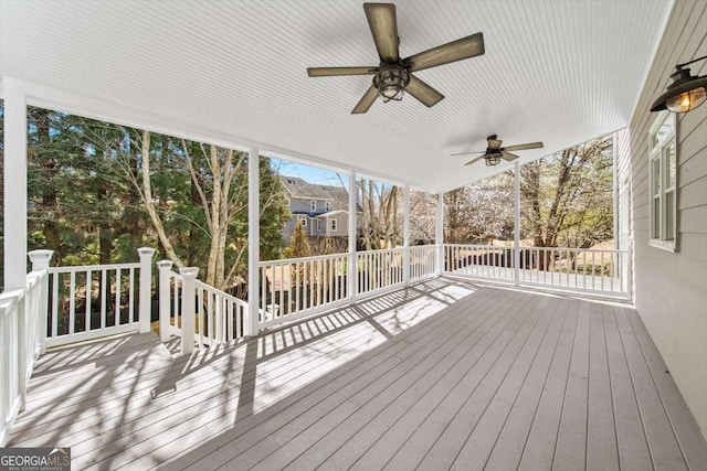 wooden deck featuring ceiling fan