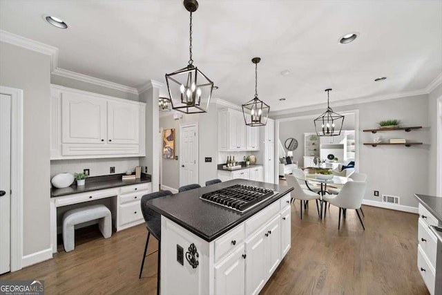 kitchen with dark countertops, visible vents, and white cabinetry