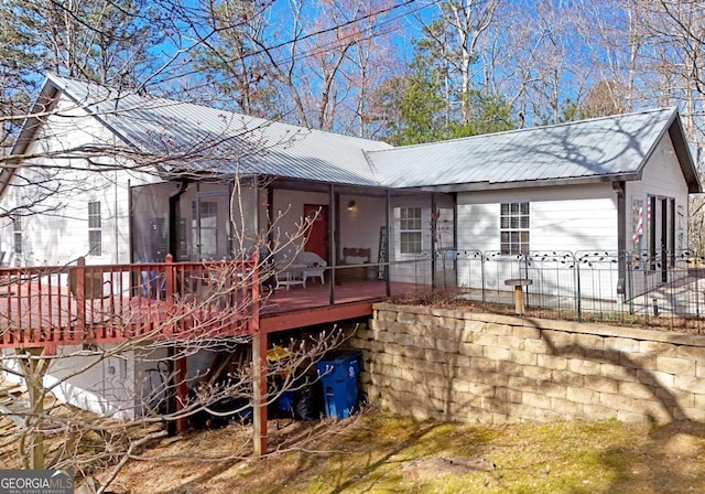 exterior space with a wooden deck and metal roof