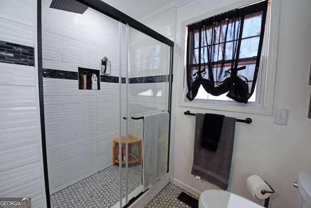 bathroom with toilet and a stall shower