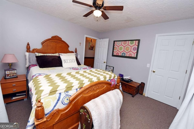 carpeted bedroom featuring a textured ceiling and a ceiling fan