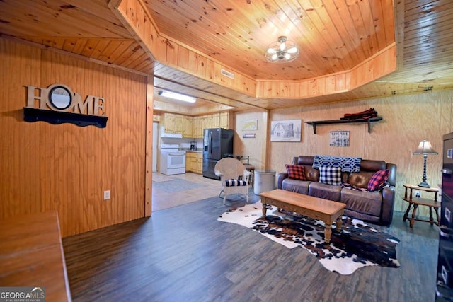 living room featuring wood finished floors, a raised ceiling, wooden ceiling, and wooden walls