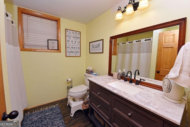 bathroom featuring toilet, curtained shower, wood finished floors, baseboards, and vanity