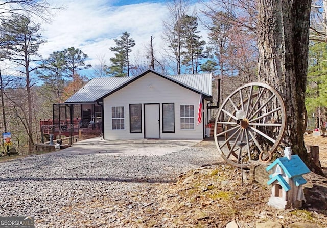 106 Opaque Way, Ellijay, GA 30540 - rear view of property featuring a metal roof, gravel driveway, and a patio