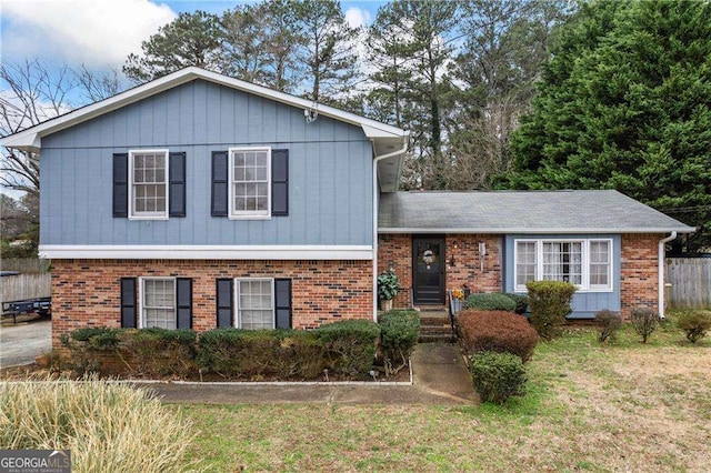 tri-level home with brick siding