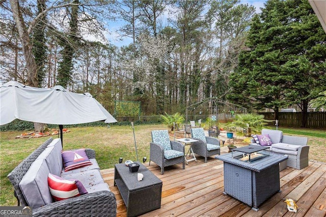 wooden deck with an outdoor living space, a lawn, and a fenced backyard