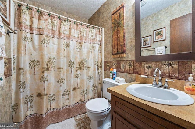 bathroom featuring toilet, a textured ceiling, vanity, and a shower with curtain