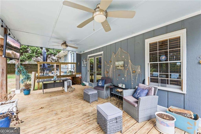 deck featuring a ceiling fan, french doors, fence, and an outdoor hangout area