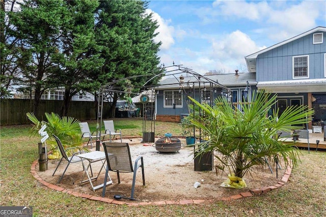 view of yard featuring a gazebo, fence, and an outdoor fire pit