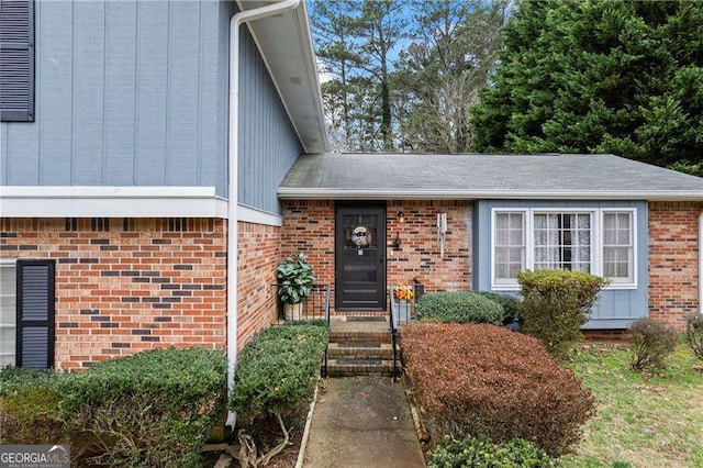 doorway to property featuring brick siding