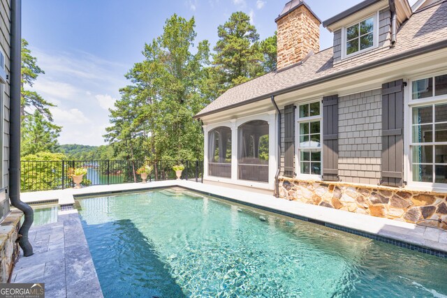 view of swimming pool with fence and a fenced in pool