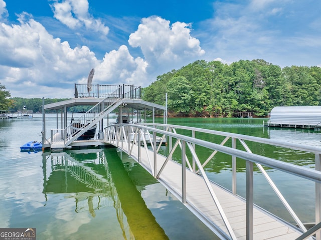 dock area featuring stairway and a water view