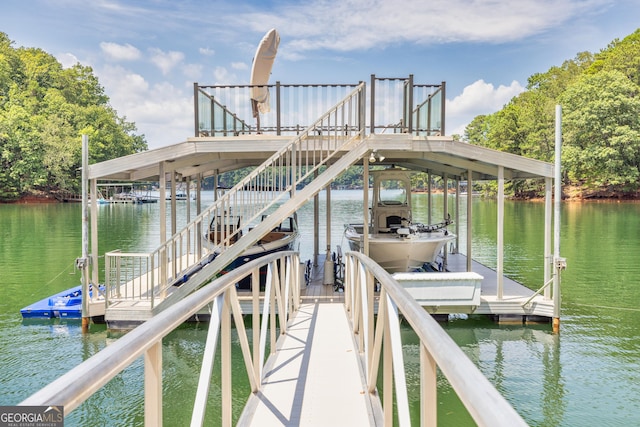 dock area with a water view and boat lift