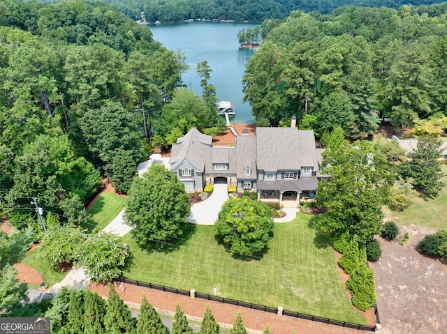 birds eye view of property featuring a water view and a view of trees
