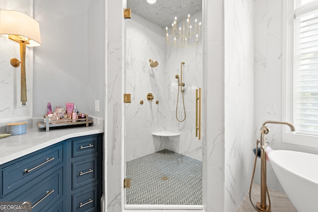 full bathroom with a soaking tub, vanity, and a marble finish shower