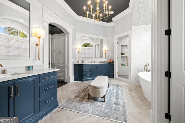 full bathroom featuring a sink, an inviting chandelier, a shower stall, two vanities, and ornamental molding
