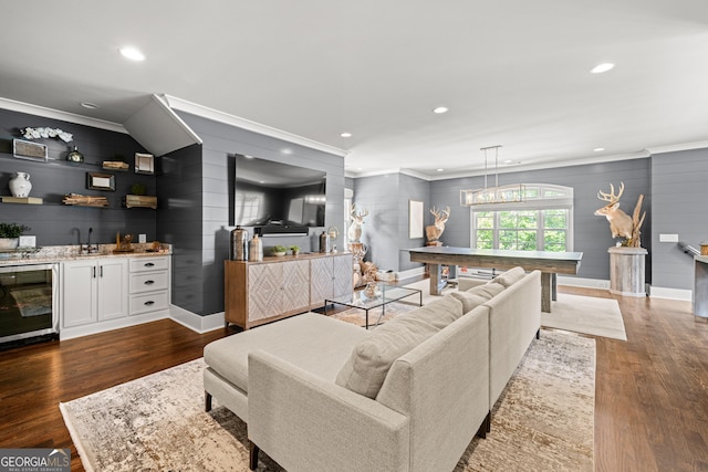 living area with wet bar, baseboards, crown molding, and wine cooler