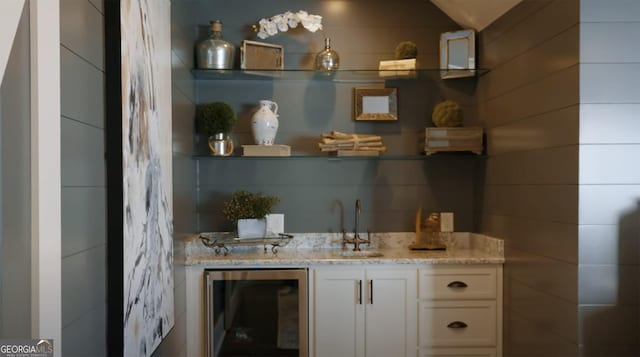 bar with wine cooler, a sink, and wet bar