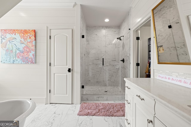 bathroom featuring recessed lighting, vanity, a marble finish shower, a freestanding bath, and marble finish floor