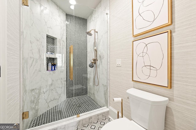 full bath featuring tile walls, a marble finish shower, and toilet