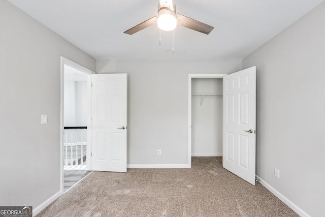 unfurnished bedroom featuring a closet, carpet flooring, a ceiling fan, and baseboards