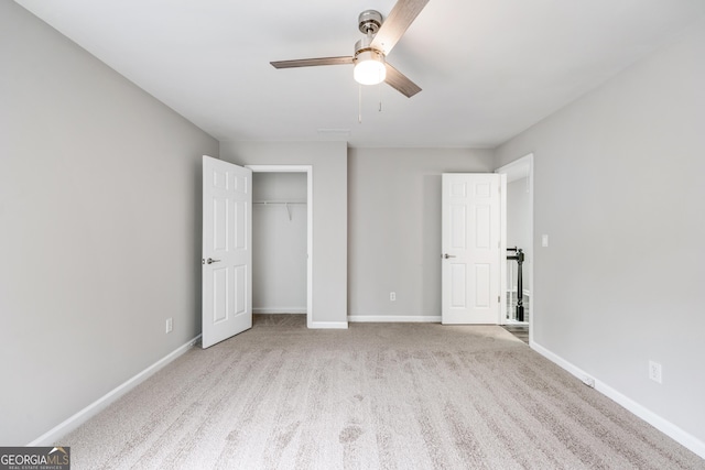 unfurnished bedroom featuring carpet flooring, a ceiling fan, baseboards, and a closet