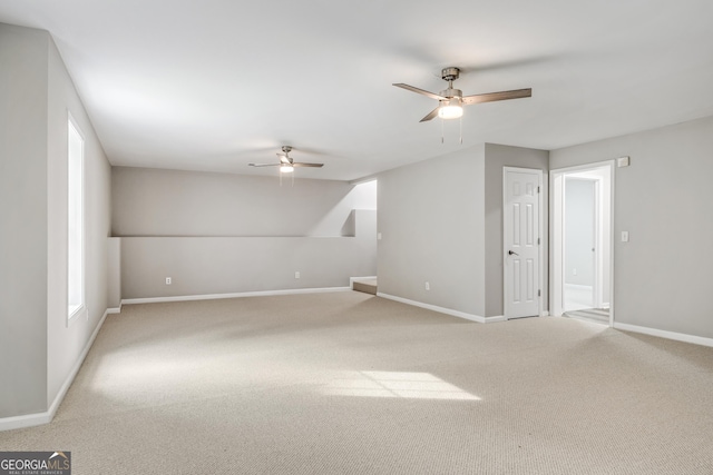 carpeted spare room with baseboards and ceiling fan