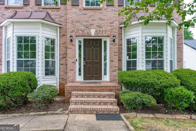 entrance to property with brick siding